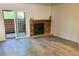 Spacious living room featuring a brick fireplace and sliding glass door for natural light and access to the outside at 2261 S Buckley Rd # 102, Aurora, CO 80013
