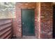 Outdoor patio area with a brick enclosure and a storage door, offering a private outdoor space at 2261 S Buckley Rd # 102, Aurora, CO 80013