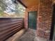Outdoor patio area with a brick enclosure and a storage door, offering a private outdoor space at 2261 S Buckley Rd # 102, Aurora, CO 80013