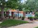 Community pool surrounded by lush greenery and a brick and iron fence, providing a serene recreational area at 2261 S Buckley Rd # 102, Aurora, CO 80013
