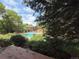 Community pool surrounded by lush greenery and trees, providing a serene recreational area at 2261 S Buckley Rd # 102, Aurora, CO 80013