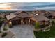 Stunning aerial view of the stone-clad home, highlighting the three-car garage, tiled roof, landscaped yard, and neighborhood at 10783 Backcountry Dr, Highlands Ranch, CO 80126