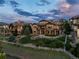 An aerial view of the home shows the multi-story deck, stone accents, and manicured lawn in a serene neighborhood at 10783 Backcountry Dr, Highlands Ranch, CO 80126