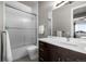 Bathroom featuring a shower/tub combo, a dark vanity with a white countertop, and modern fixtures at 10783 Backcountry Dr, Highlands Ranch, CO 80126