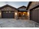 Beautiful stone-clad home with a three-car garage, gated entrance, and meticulously maintained landscaping showcasing the curb appeal at 10783 Backcountry Dr, Highlands Ranch, CO 80126