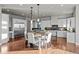 Bright and modern kitchen with white cabinets, stainless steel appliances, and wood floors at 10783 Backcountry Dr, Highlands Ranch, CO 80126