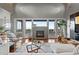 Spacious living room featuring a modern fireplace, large windows with views, and stylish furnishings for comfortable living and entertaining at 10783 Backcountry Dr, Highlands Ranch, CO 80126