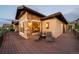 The exterior of the home includes outdoor seating on a deck made of Trex and stone accents at sunset at 10783 Backcountry Dr, Highlands Ranch, CO 80126