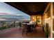 Covered outdoor patio with a wood ceiling, string lights, mountain views, and table and chairs with a grill nearby at 10783 Backcountry Dr, Highlands Ranch, CO 80126