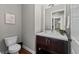 Powder room boasts modern fixtures, floating vanity, and hardwood floors at 10783 Backcountry Dr, Highlands Ranch, CO 80126