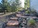Beautiful backyard with a stone walkway and lush landscaping, offering a serene outdoor experience at 2010 Saddleback Dr, Castle Rock, CO 80104