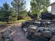 Landscaped backyard featuring a stone path and terraced seating area with outdoor furniture at 2010 Saddleback Dr, Castle Rock, CO 80104