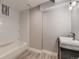 Bathroom features a tub and shower, modern vanity and fixtures, and tiled walls at 2010 Saddleback Dr, Castle Rock, CO 80104