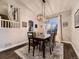 Bright dining room with modern chandelier, large window, and comfortable seating for six at 2010 Saddleback Dr, Castle Rock, CO 80104