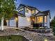 Charming two-story home featuring stone accents, manicured landscaping, and a welcoming front porch at 2010 Saddleback Dr, Castle Rock, CO 80104