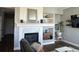 Elegant fireplace with decorative mantel, tiled hearth, and built-in shelving at 2010 Saddleback Dr, Castle Rock, CO 80104