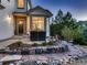 Inviting home exterior with stone accents, patio seating, and professionally landscaped front yard at 2010 Saddleback Dr, Castle Rock, CO 80104