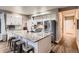Bright kitchen with stainless steel appliances, white cabinets, and a large granite island with seating at 2010 Saddleback Dr, Castle Rock, CO 80104