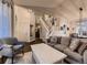 Open-concept living room with staircase, comfortable seating, and ample natural light at 2010 Saddleback Dr, Castle Rock, CO 80104