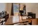 Home office featuring a large wooden desk and a window offering natural light at 2010 Saddleback Dr, Castle Rock, CO 80104