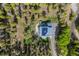 Modern home with solar panels on a vast wooded lot featuring a fire pit and hot tub at 6803 Snowshoe Trl, Evergreen, CO 80439