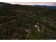 Breathtaking aerial shot of mountain community amidst lush forest with stunning mountain views at 6803 Snowshoe Trl, Evergreen, CO 80439