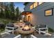 Inviting backyard patio with a stone fire pit and comfortable seating perfect for outdoor entertaining at 6803 Snowshoe Trl, Evergreen, CO 80439