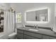 Bright bathroom with modern vanity, sleek faucet, and decorative hexagon tile accents at 6803 Snowshoe Trl, Evergreen, CO 80439