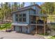 Modern home with garage space, deck, and outdoor entertainment. Beautiful natural forest setting at 6803 Snowshoe Trl, Evergreen, CO 80439