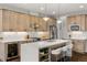 Bright, modern kitchen features white quartz countertops, wood cabinets, and a wine cooler at 6803 Snowshoe Trl, Evergreen, CO 80439