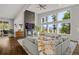 Bright living room with large windows, a modern fireplace, and stylish decor with views of nature at 6803 Snowshoe Trl, Evergreen, CO 80439