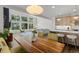 Open-concept living space connects the dining area and kitchen with floor-to-ceiling windows at 6803 Snowshoe Trl, Evergreen, CO 80439