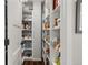 Walk-in pantry with ample shelving for organized storage of food and kitchen essentials at 6803 Snowshoe Trl, Evergreen, CO 80439