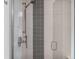 Modern shower featuring stylish tile work and a shower head, creating a luxurious and inviting space at 6803 Snowshoe Trl, Evergreen, CO 80439