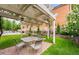 Outdoor patio featuring a pergola over outdoor table with chairs; in-ground pool in background at 1223 Race St # 402, Denver, CO 80206