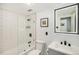 Bright bathroom featuring a glass-enclosed shower with white subway tile and matte black hardware at 1223 Race St # 402, Denver, CO 80206