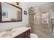 Bathroom features a vanity with a stone countertop and a walk-in shower with glass doors at 1223 Race St # 402, Denver, CO 80206