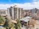Exterior of a high-rise building featuring multiple balconies and mature trees in an urban setting at 1223 Race St # 402, Denver, CO 80206