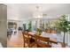 Open dining and living area with natural light and sliding glass doors to a balcony with great tree views at 1223 Race St # 402, Denver, CO 80206