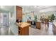 Contemporary kitchen featuring sleek cabinetry, stainless steel appliances, breakfast bar, and seamless dining access at 1223 Race St # 402, Denver, CO 80206