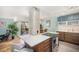 Open-concept kitchen with concrete pillar detail connecting to the dining area, updated cabinetry, and stainless appliances at 1223 Race St # 402, Denver, CO 80206
