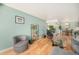 Living area with hardwood floors, a cozy chair, and seamless access to the dining area at 1223 Race St # 402, Denver, CO 80206