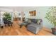 Bright living space with a comfortable gray sectional sofa and open access to the kitchen and dining area at 1223 Race St # 402, Denver, CO 80206