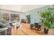 Inviting living room with wood floors, comfortable seating and sliding glass doors to a cozy balcony at 1223 Race St # 402, Denver, CO 80206