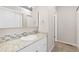 Bathroom featuring a granite countertop vanity and backsplash, creating a serene and spacious atmosphere at 4694 S Fraser Ct # A, Aurora, CO 80015
