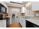 Bright kitchen featuring granite countertops, stainless steel appliances, and an open layout to the living area at 4694 S Fraser Ct # A, Aurora, CO 80015