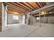 Unfinished basement featuring concrete flooring and exposed ceiling beams at 5191 S Hannibal Way, Centennial, CO 80015