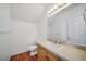 Well-lit half bathroom featuring wood floors and a neutral vanity at 5191 S Hannibal Way, Centennial, CO 80015