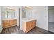 Dual vanities provide optimal space in this bathroom with wood-look vinyl flooring at 5191 S Hannibal Way, Centennial, CO 80015
