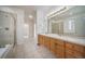 Bathroom featuring a double vanity, tile floors, and a glass-enclosed shower at 5191 S Hannibal Way, Centennial, CO 80015